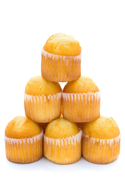 Golden cup cakes stack up on a white background — Stock Photo, Image