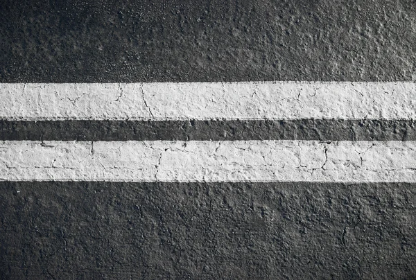 Double yellow lines divider on blacktop — Stock Photo, Image