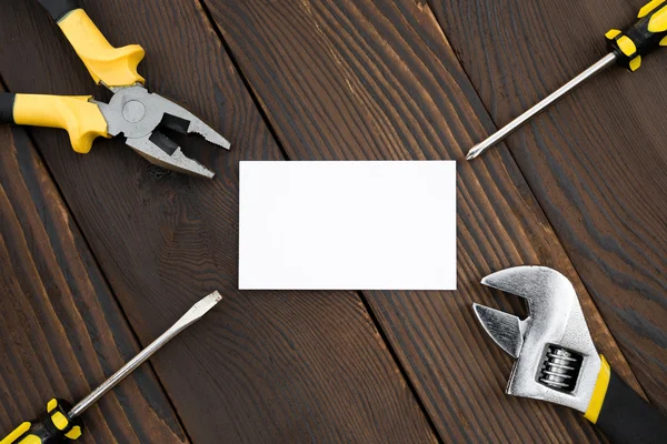 Blank card and tools on wood — Stock Photo, Image