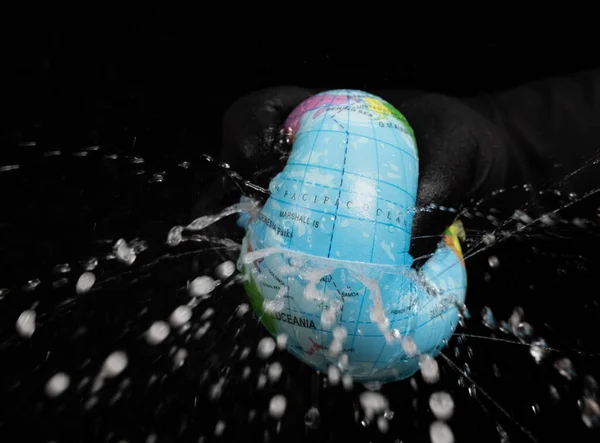 Squeezing Globe Water Flying Out Concept Human Overusing Water Resource — Stock Photo, Image