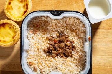 fresh self cooking fast food of rice with egg tart and yogurt