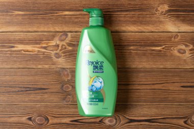Zhongshan;China-November 5, 2021:bottle of Rejoice shampoo on wood background.ound.