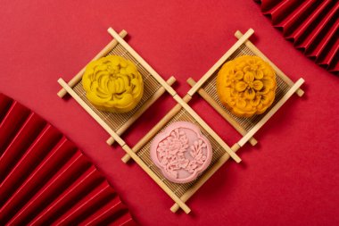trendy flower shape mooncake on red background