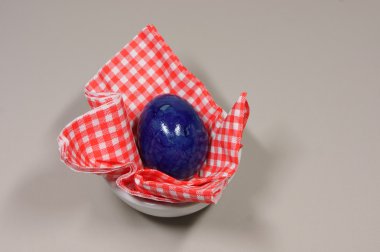 egg in eggcup on red white checkered napkin clipart