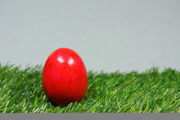 Colorful easter eggs on a lawn of artificial green — Stock Photo, Image