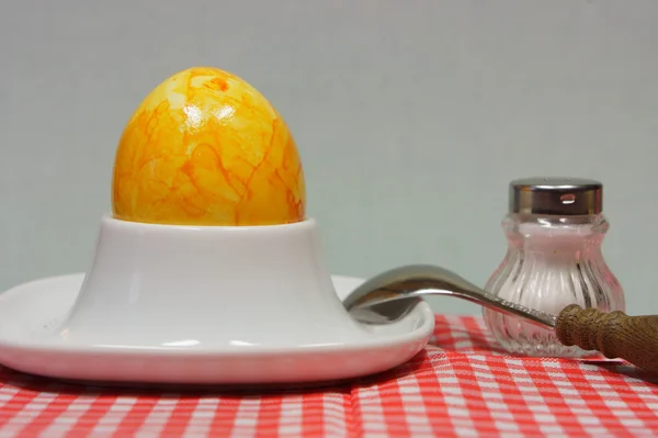 Egg in eggcup on red white checkered napkin — Stock Photo, Image