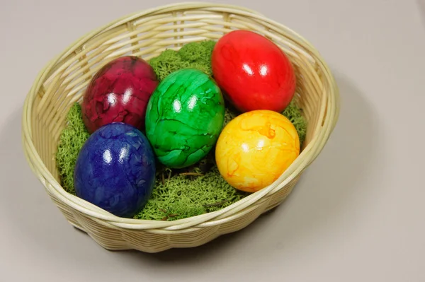 Colorful easter eggs in a basket — Stock Photo, Image