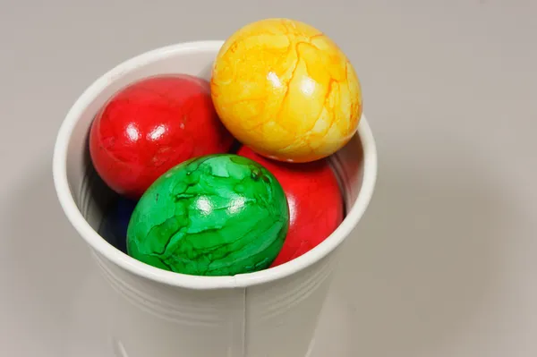 Colorful easter eggs in a basket — Stock Photo, Image