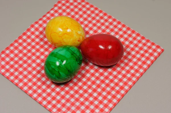 Colorful eggs on a red and white napkin — Stock Photo, Image