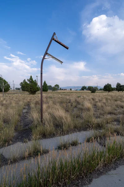 Rusted old signpost in the middle of a weed-chocked lot, in the ghost town of Jeffrey City Wyoming