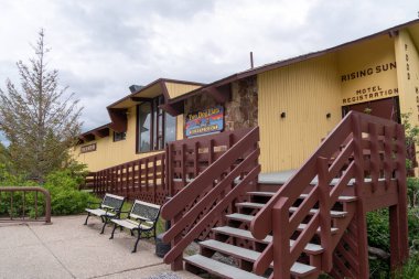 Montana, USA - July 4, 2022: Exterior doors and entrance to the Rising Sun Motor Inn motel registration desk and Two Dog Flats restaurant in Glacier National Park