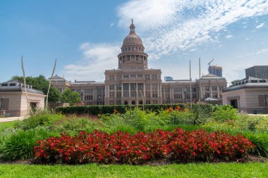 Austin, Texas - May 23, 2022: Exterior view of the Texas State Capitol building, with flowers in the foreground