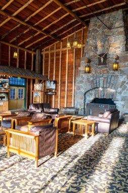 Wyoming, USA - July 19, 2022: Inside the lobby seating area with fireplace at the Old Faithful Inn in Yellowstone National Park