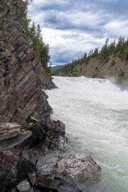 Bow Falls waterfall in Banff, Alberta Canada on a cloudy summer day