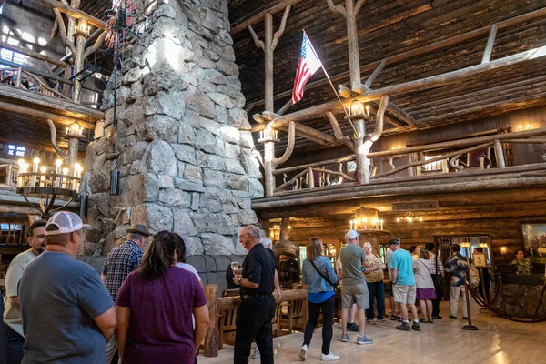 Wyoming, USA - July 18, 2022: Long lines of people waiting for seating inside the Old Faithful Inn dining room for the buffet dinner