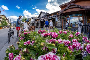 Banff, Alberta, Canada - July 10, 2022: Fisheye view of tourists shopping in downtown Banff clipart