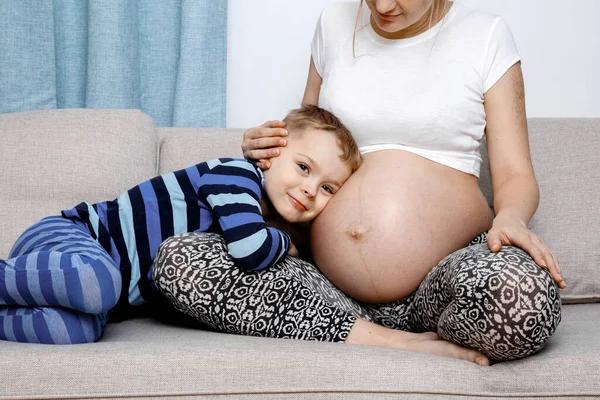 Child Hugs Her Mother Pregnant Belly Happy Family Life Expectation Stock Picture