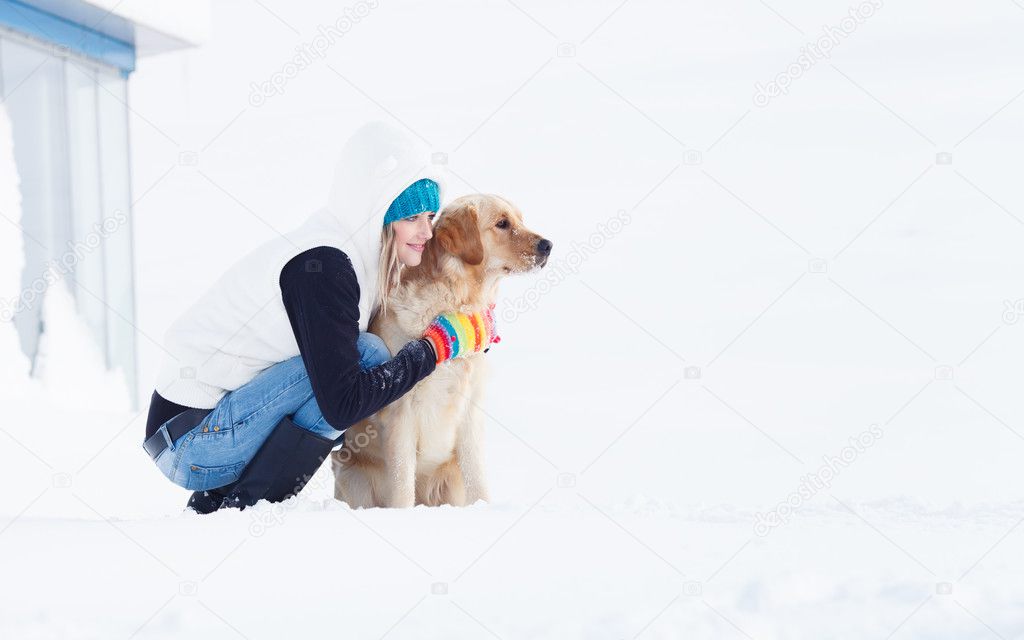 Beautiful Girl with her dog in winter outdoors.