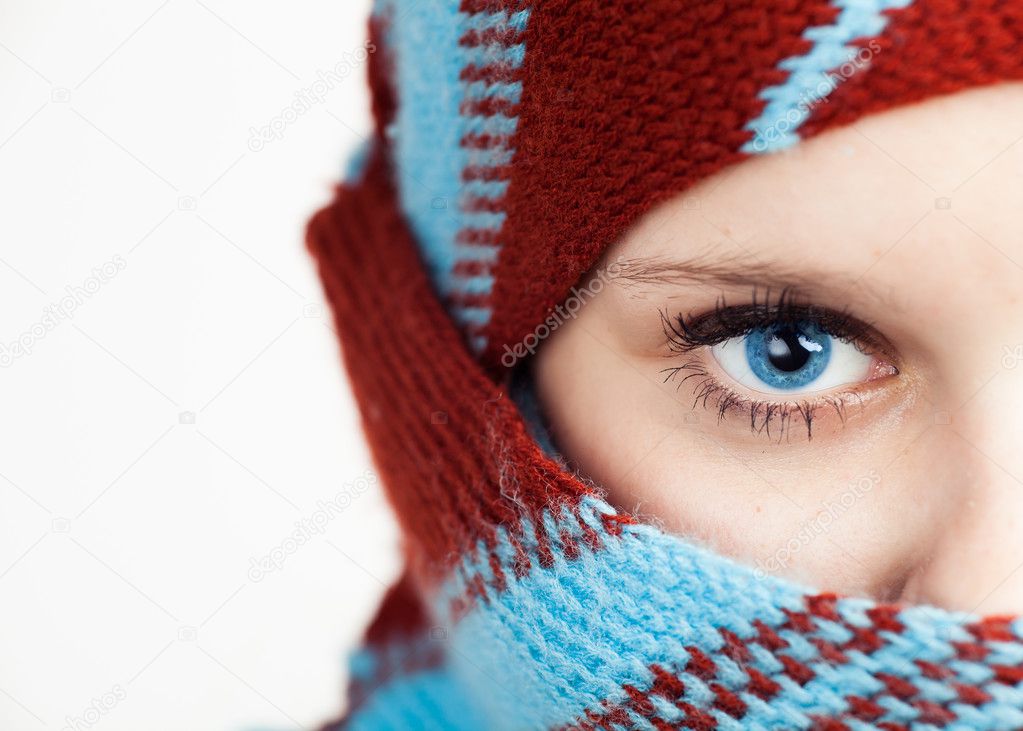 Half face portrait of beautiful young woman wearing shawl