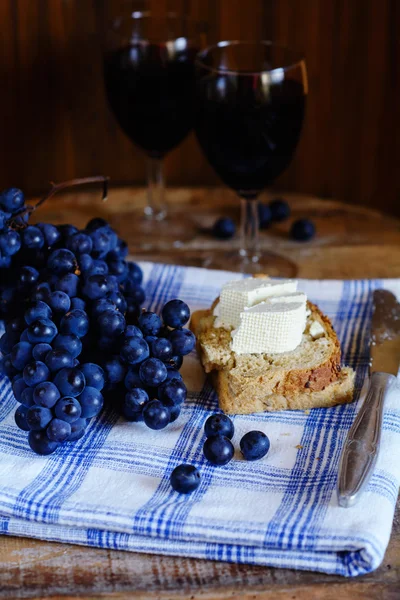 Delicious appetizer with wine, grapes, bread