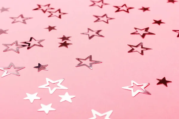 Festive pastel pink background with metallic confetti. — Stock Photo, Image