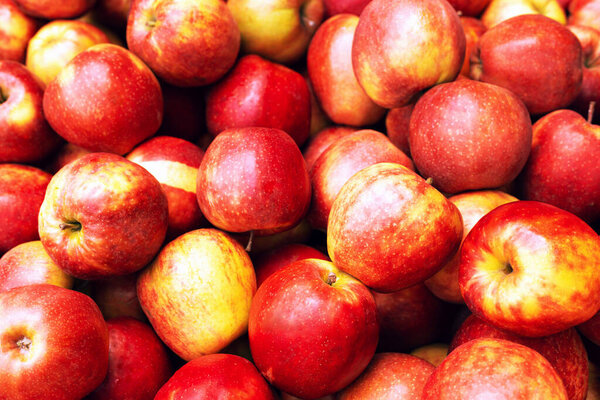 Fresh juicy red apples from the market piled in a heap.