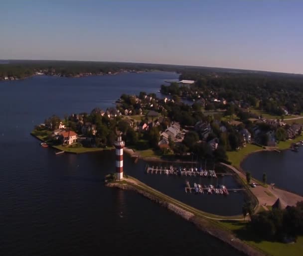 Aerial shot of lighthouse with sparkling water — Stock Video