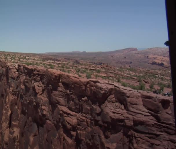 Aerial shot of three mountain bikers on red Ridge — Stock Video