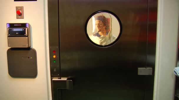 Scientist in bubble suit exits airlock — Stock Video