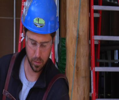 Construction worker looks in camera