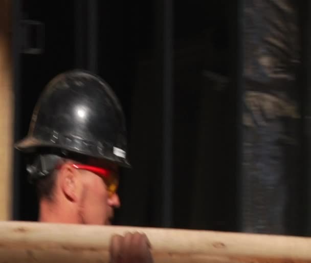 Construction worker carries wood beam — Stock Video