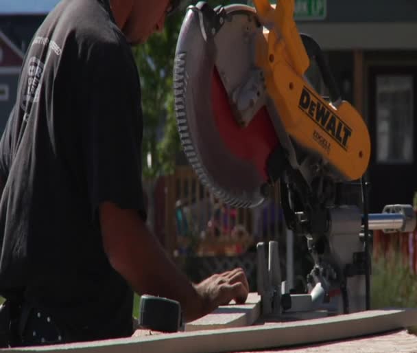 Man operates chop saw — Stock Video