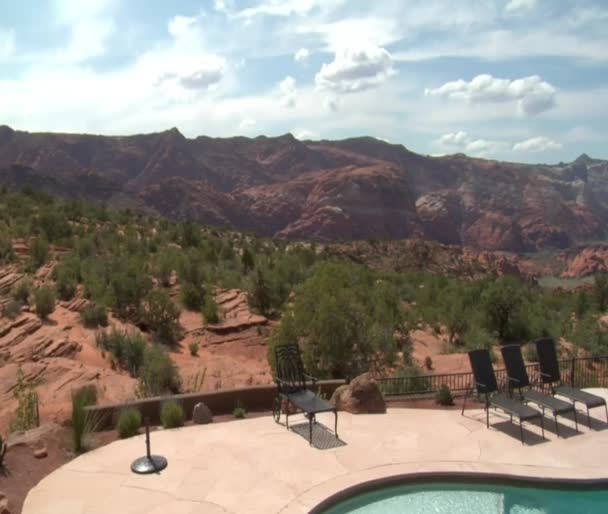 Beautiful pool with Redrock desert in distance — Stock Video