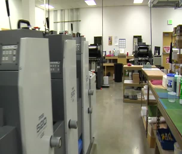 Steadicam shot through print shop — Stock Video