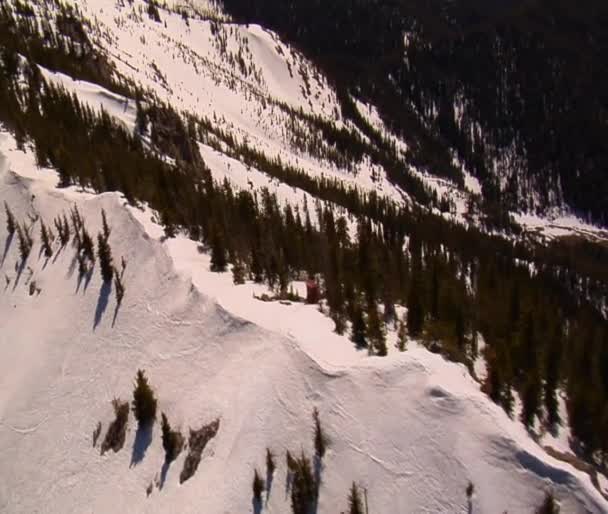 Aerial shot of snowy mountain saddle — Stock Video