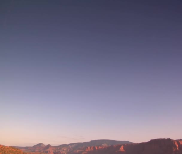 Couple sits on a red rock cliff — Stock Video