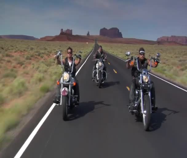 Tre cyklister på en redrock desert highway — Stockvideo