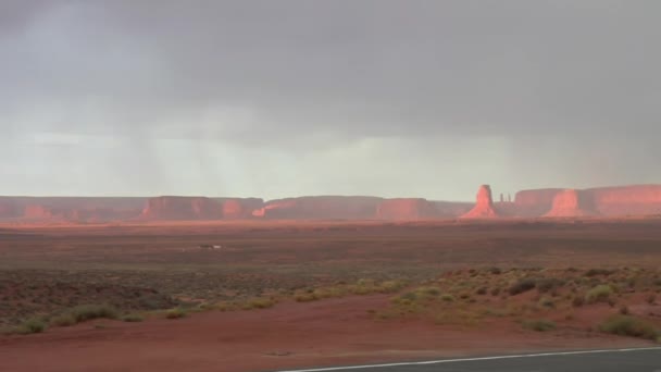 Panning shot of Monument Valley Highway and rainbow — Stock Video