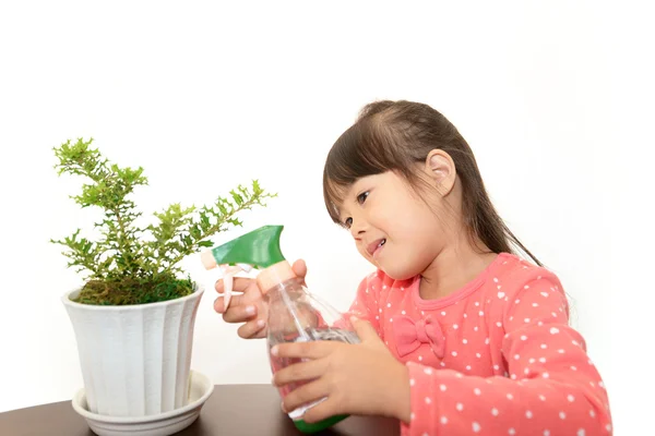 Smiling Asian girl with plant — Stock Photo, Image