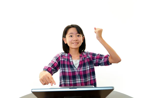 Smiling girls using a laptop — Stock Photo, Image