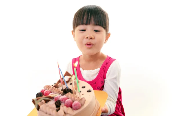 Little girl blowing birthday candles — Stock Photo, Image