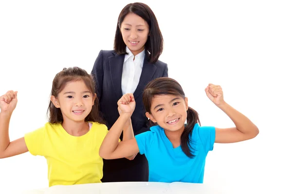 Smiling teacher with girls — Stock Photo, Image