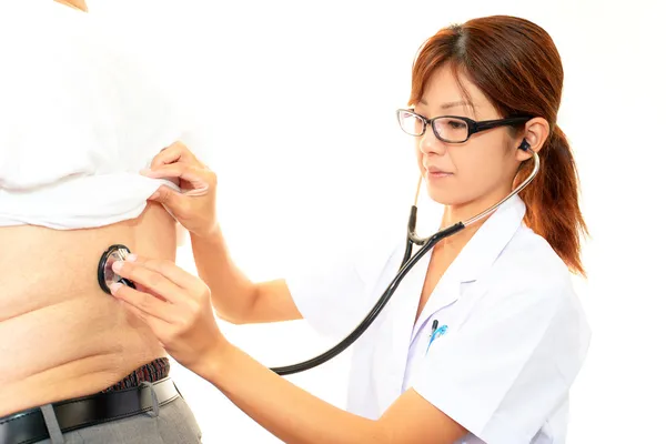 Serious doctor examining a patient obesity — Stock Photo, Image