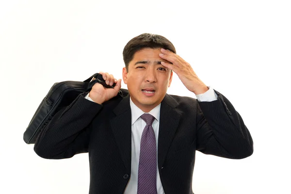 Tired and stressed Asian businessman — Stock Photo, Image