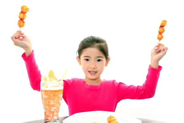 Happy child eating sweets — Stock Photo, Image