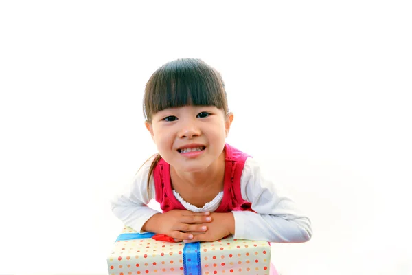 Joyful little girl holding present in hands — Stock Photo, Image