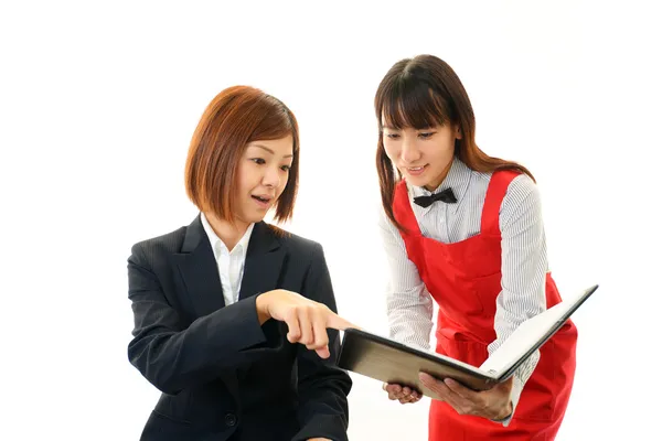 Waitress shows the menu to customer — Stock Photo, Image