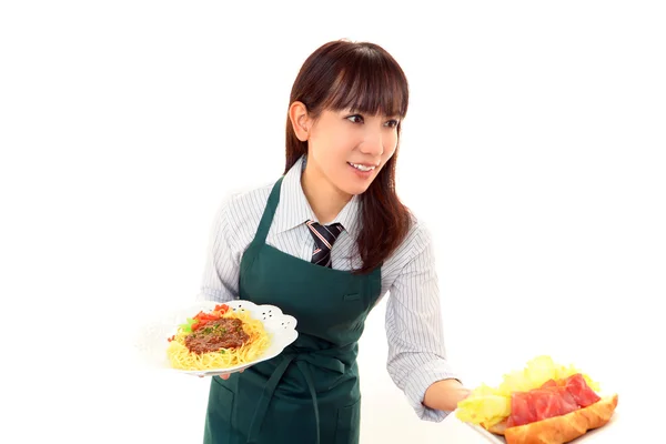 Waitress delivering meals to table — Stock Photo, Image