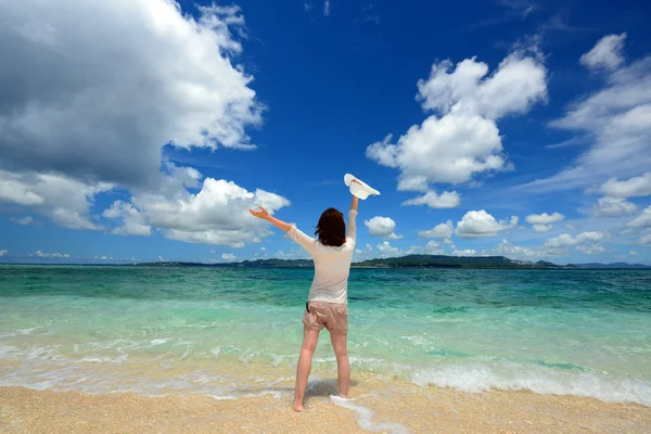 Mujer joven en la playa disfrutar de la luz del sol — Foto de Stock