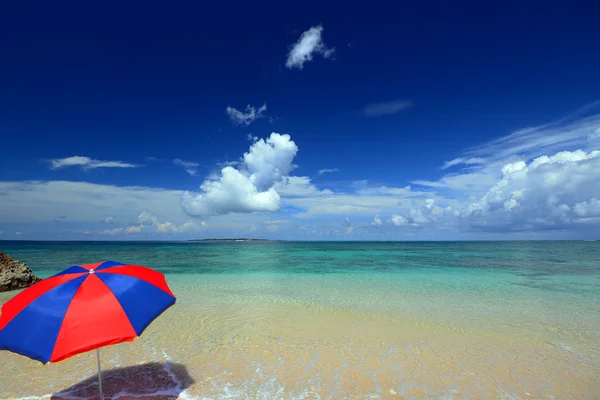 La playa y el paraguas de la playa de mediados de verano . —  Fotos de Stock